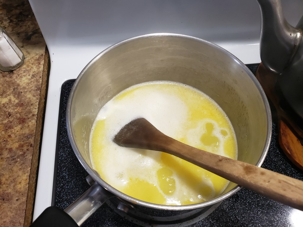 Butter and water being boiled on the stove top during cannabis edibles process