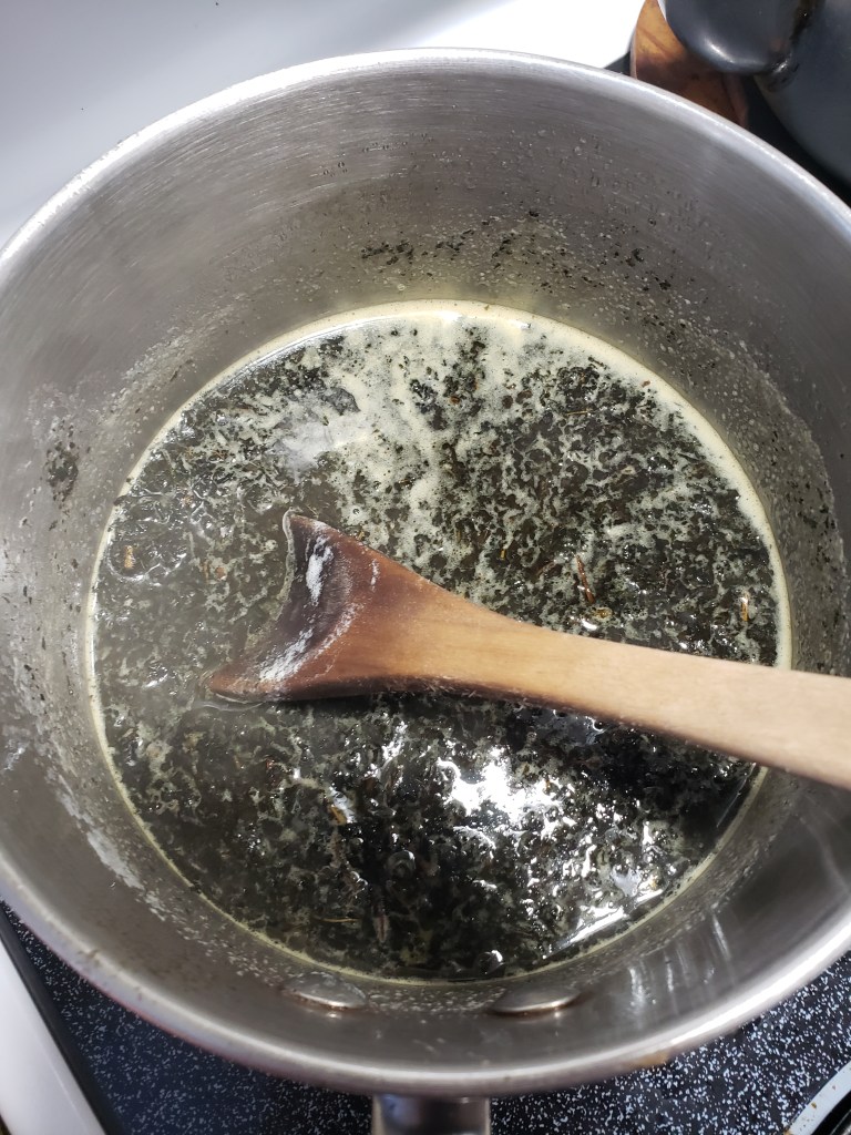 Cannabis and butter mixture on stove top being combined 