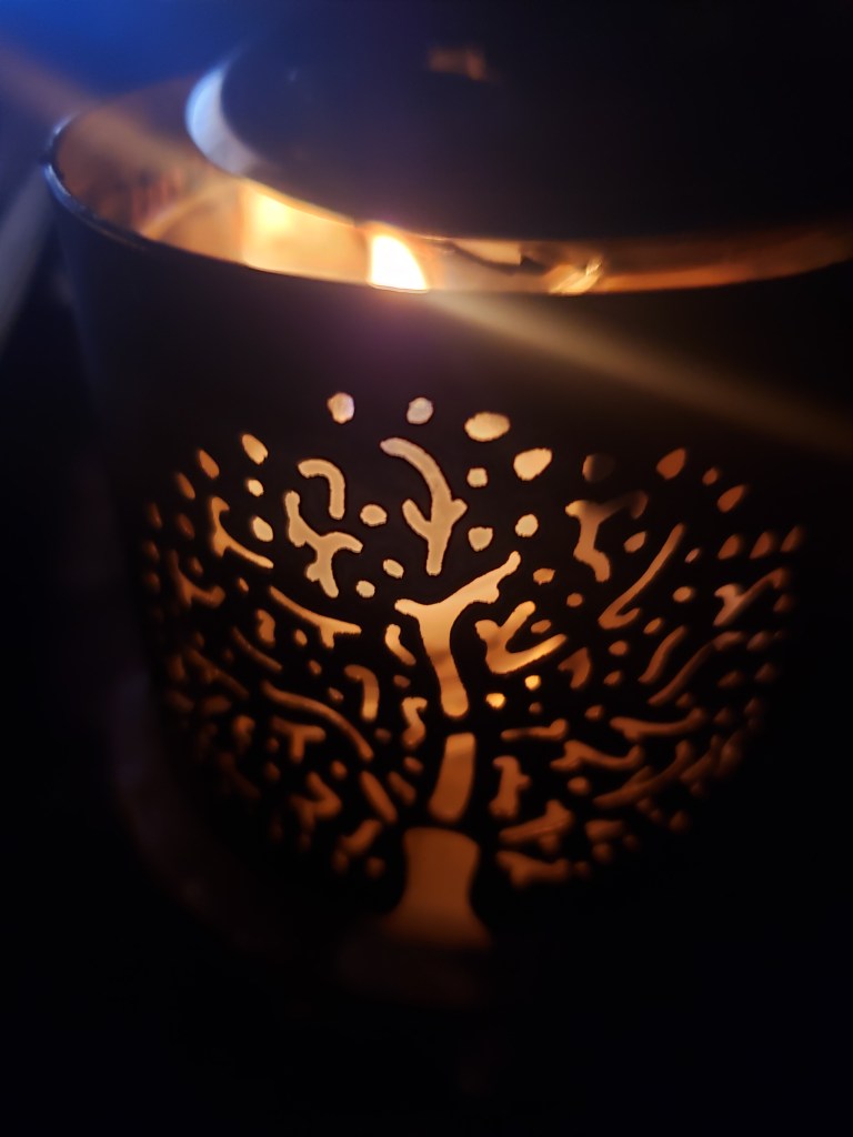 A candle burns the inside of a scented device used for mediation and enlightenment 