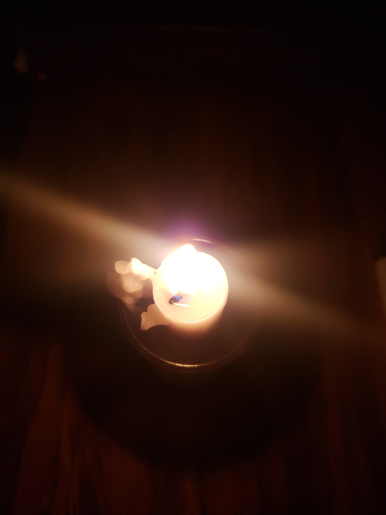 Candle burning during the night while image is captured from above March 2022